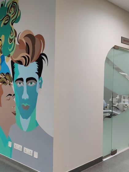 The mural in the hospital corridor, serving as a beacon of positivity and human connection for patients and staff.
