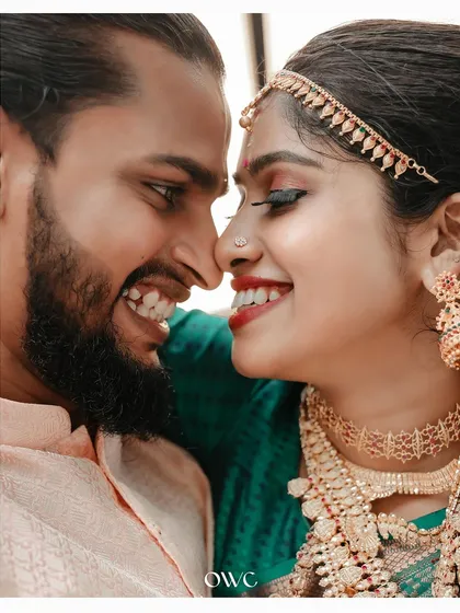 It's the small, intimate gestures that tell the biggest stories. This close-up from a Kerala wedding captures the pure joy and affection between the couple, a candid moment that you will cherish forever.