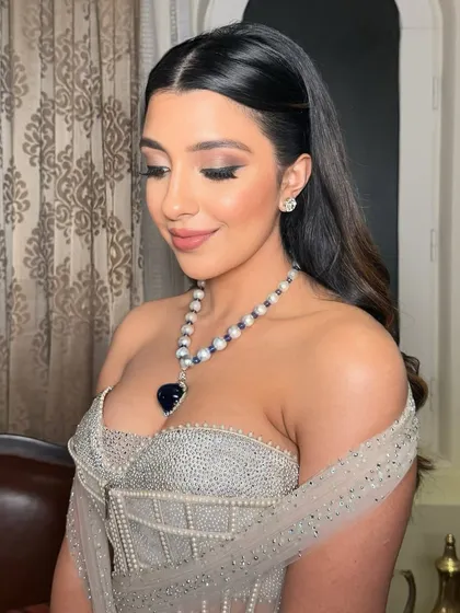 A close-up of Rhea's vintage-inspired reception makeup. The sharp liner and glossy lips are timeless and elegant.
