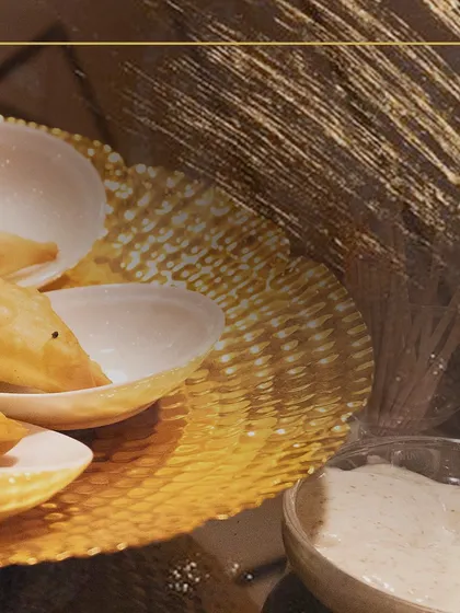 Another angle of our carefully plated appetizers, complete with a side of dipping sauce, showcasing our attention to the complete flavor experience.