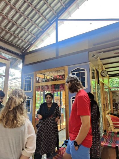During a museum tour, I enjoy sharing the stories behind specific puppets and traditions. Here, I am speaking with a group of students about the different styles of puppets in our collection.