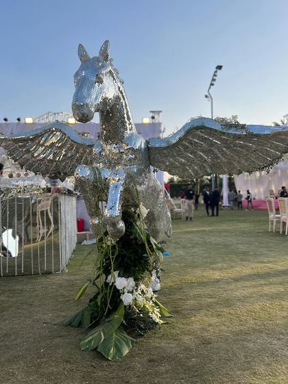 A whimsical and majestic element from a cocktail party: a life-sized Pegasus statue covered in silver mirror work. This piece served as a stunning photo opportunity and added a touch of mythical glamour to the event.