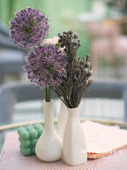 A detail of the floral arrangements in 'The Conservatory', featuring unique blooms like allium.
