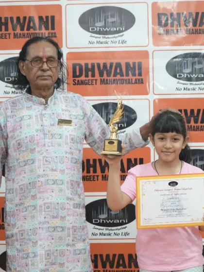 A senior guru stands proudly with one of our young award winners.