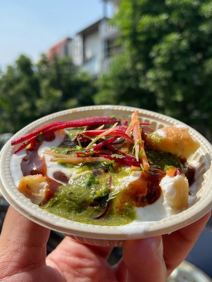 Our Bhalla Papdi Chaat is a burst of flavours. It has soft lentil dumplings (bhalla) and crispy wafers (papdi) topped with yogurt, tamarind chutney, and mint chutney.