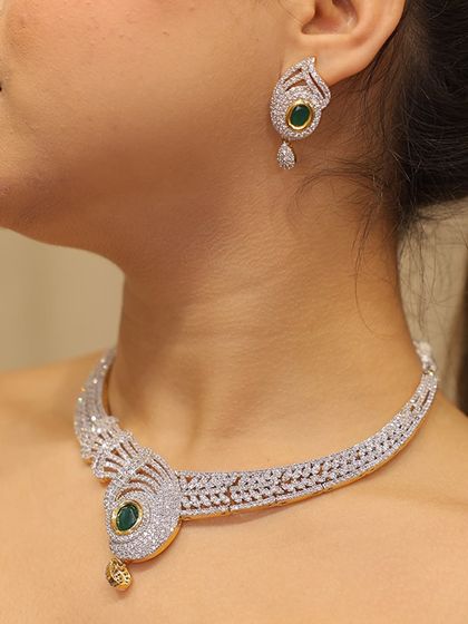 A unique peacock-inspired necklace with an emerald centerpiece. This is a statement piece of rental jewelry that is sure to get you noticed.
