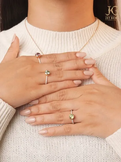 A touch of colour for your daily elegance. These delicate rings feature vibrant gemstones like amethyst and peridot on thin, sparkling diamond bands. They are perfect for stacking or wearing alone for a subtle hint of personality.