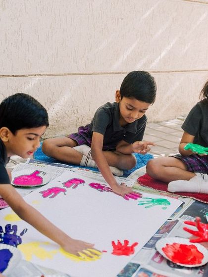 My educational approach is immersive and engaging. Here, children get their hands dirty with finger painting, a tactile and joyful way to learn about color and texture.
