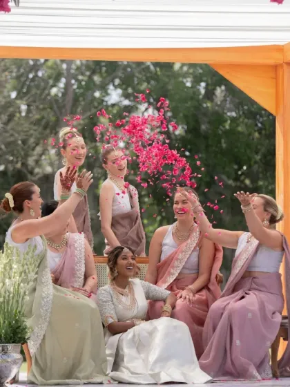 A fun-filled moment with the bride and her friends, where her stained henna adds to the festive atmosphere.