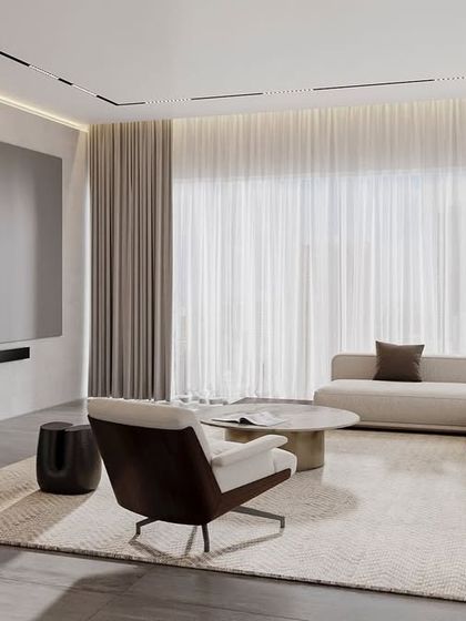 This media room is designed for relaxation. The large projector screen, comfortable sofa, and minimalist decor create an uncluttered and immersive viewing experience.