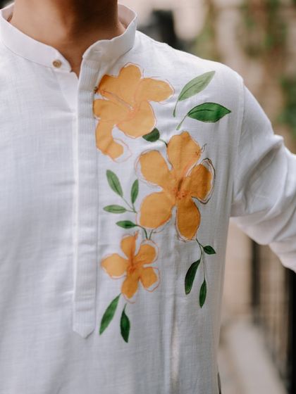 A detail shot of the groom's custom hand-painted kurta for the Haldi ceremony. I love capturing these unique, personal touches.