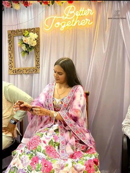 A happy client in a beautiful floral lehenga, perfect for a daytime function.