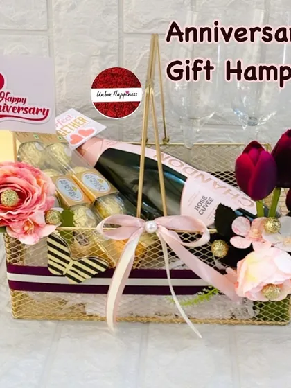 I design elegant anniversary hampers to celebrate milestones of love. This basket features a bottle of sparkling rosé, Ferrero Rocher chocolates, and champagne glasses, all presented in a stylish gold wire basket perfect for a romantic evening.