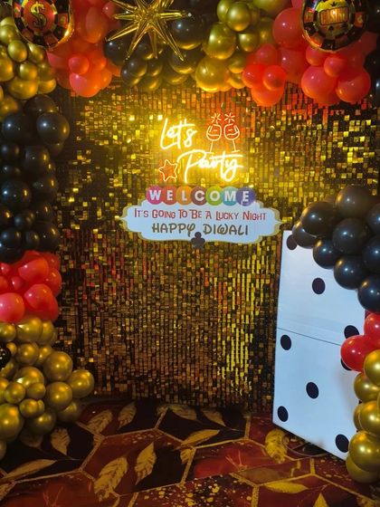 A clear, well-lit shot of the casino party photo booth, showing the neon sign and custom welcome message.