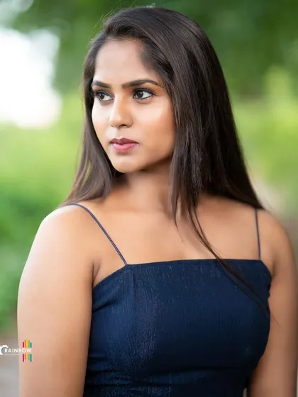A stylish outdoor portrait. The pose and expression convey confidence and modern elegance.