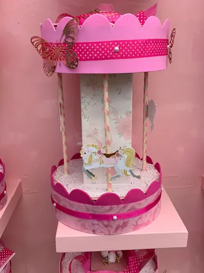 The magic is in the details. These beautiful miniature carousels were created as party favors for a 'Golden Horses & Magical Unicorns' theme. Each one is handmade with intricate papercraft details, giving guests a special keepsake to take home.