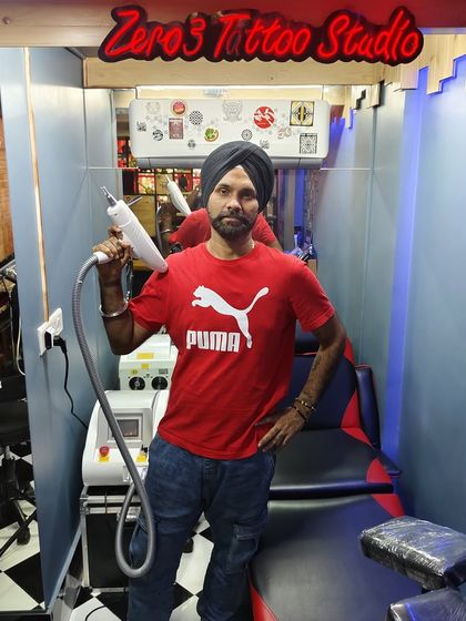 Posing with the equipment I trust for all my laser tattoo removal services. This machine is the heart of our removal process, delivering consistent results in a clean and professional environment. I stand by the quality and safety of the technology we use at Zero3 Studio.