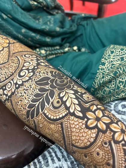 Another detailed shot of Nazreen's forearm, highlighting the bold floral and leaf motifs.