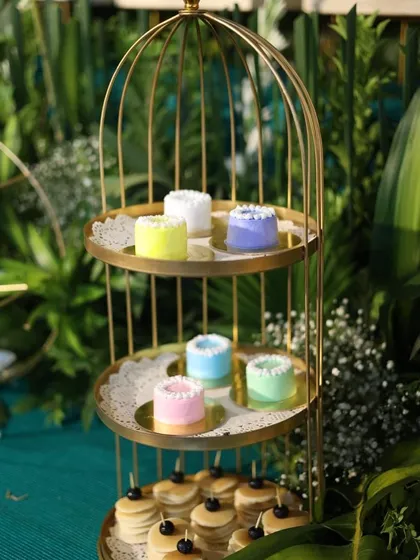 Our mini cakes displayed on a three-tiered golden stand. This elegant presentation makes them a beautiful addition to any dessert table.