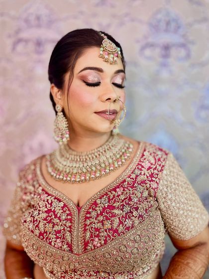 A soft and dreamy close-up. The shimmering eyeshadow and gentle pink tones create a romantic and ethereal bridal look.