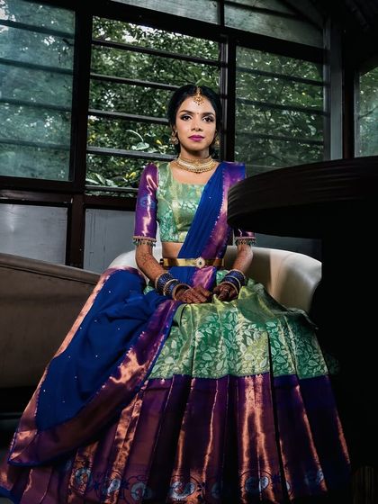 A regal portrait of the bride. The rich colors of her outfit are complemented by a polished and sophisticated makeup look.