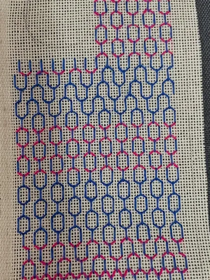 A phone insert being made with a two-tone geometric pattern. The video shows the different stages, from the first few stitches to the nearly completed piece.