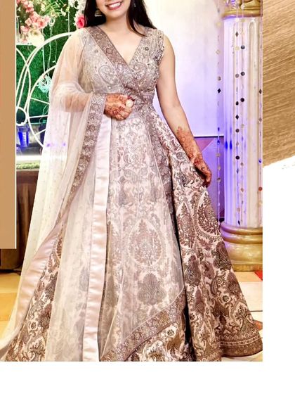 A beautiful, heavily embroidered lehenga that is perfect for a sangeet or reception. The intricate patterns and rich fabric give it a very luxurious feel.