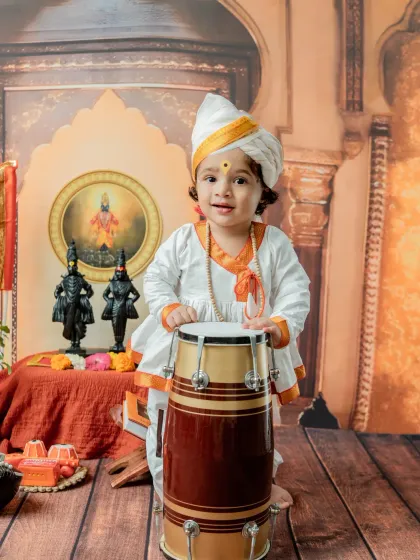 This little Varkari stands proudly with his dhol (drum). This shot is great for toddlers who are stable on their feet, capturing their playful energy and the spirit of the pilgrimage.