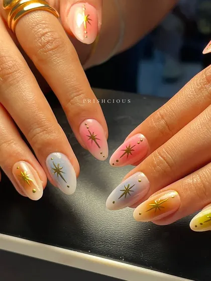 Aura nails are such a vibe, and this set is a total fav. I created a soft, multi-color gradient on each nail using dreamy pastels like pink, yellow, and blue, then topped them with delicate gold starbursts for that extra sparkle.