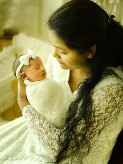 The bond between a mother and her newborn is undeniable. This photo captures that loving gaze in a soft, warm light, creating a timeless "Mumma and me" portrait.