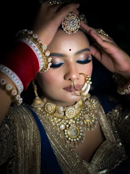 An artistic close-up of the blue eye makeup. This shot emphasizes the precision of the liner and the blend of the eyeshadows.