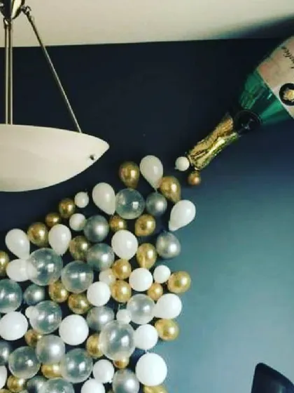 I can create fun and creative balloon art, like this champagne bottle design. It's a unique centerpiece that adds a playful and celebratory touch to any birthday or anniversary party.