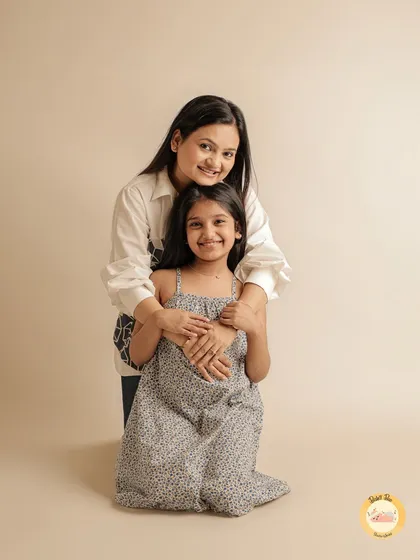 A mother and her older daughter share a special moment. We create portraits that celebrate the evolving relationship between parents and their growing children.