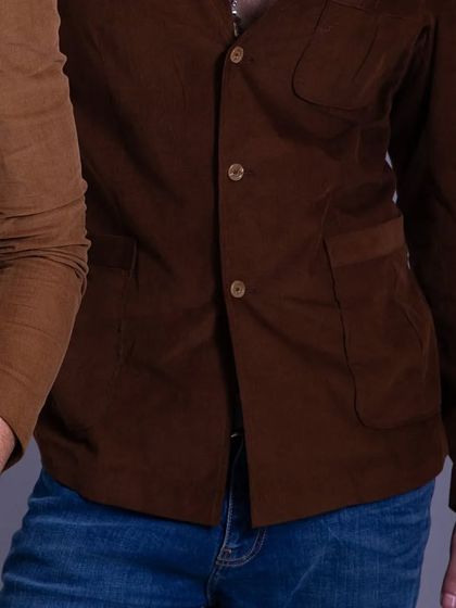 A detail shot of two corduroy blazers, showing the texture and color variations available. Bespoke is about finding the perfect piece for your personal style.