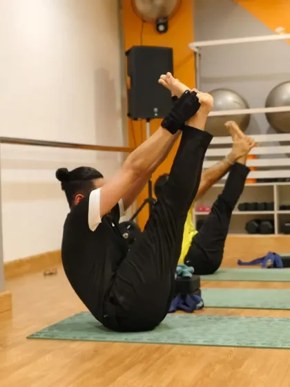 Finding balance and strength in this challenging leg hold pose. This is a testament to the focus and dedication our clients bring to the mat every day.