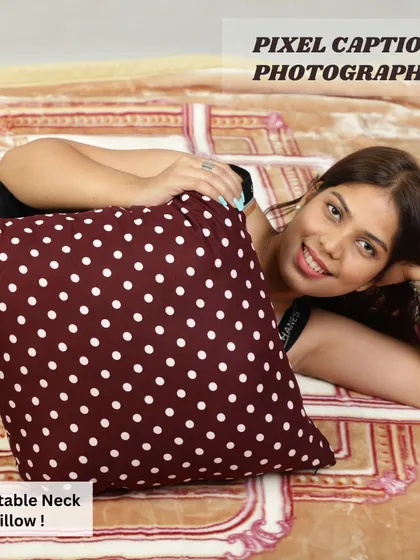 A model lying down and smiling with a polka-dot cushion. Happy, relaxed models help create a positive association with your product.
