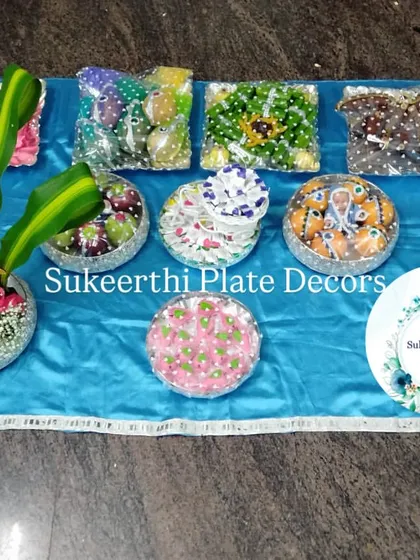 For this ear piercing ceremony in Coimbatore, I created a set of platters with a vibrant blue theme. The arrangement includes decorated sweets, dry fruits, and a floral centerpiece, all wrapped and ready for the function.