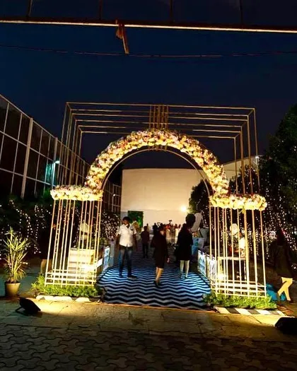 The entrance arch at night, lit up to create a dramatic and welcoming entryway for the evening's festivities.