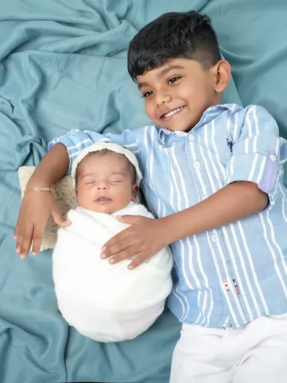 The proud big brother. Capturing the first moments between siblings is so important. The gentle way he holds his new baby sibling is just priceless.