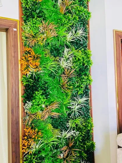 This framed vertical garden panel incorporates autumn colors with yellow and white foliage mixed into the green. It's a great way to add warmth and seasonal variety to your interior decor.