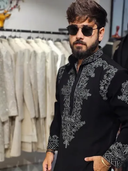 The client looking cool and confident in the black embroidered kurta.