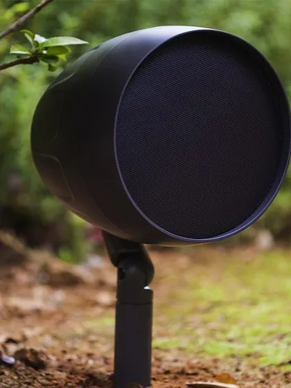 A closer look at an outdoor satellite speaker. These durable, all-weather units are designed to be staked into the ground and aimed towards listening areas, delivering high-quality audio that evenly covers your outdoor living spaces.