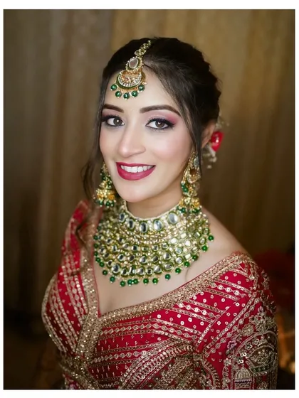 The radiance of a Punjabi bride is unmatched. I focus on creating portraits that highlight not just the stunning red lehenga and royal kundan jewelry, but also the bride's personality and joyful anticipation. This is a classic bridal portrait that celebrates heritage and elegance.