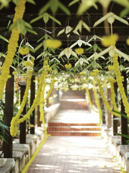 This is a closer, artistic shot of the decorated trellis walkway. The focus on the hanging floral elements highlights the detailed craftsmanship involved in the decor.