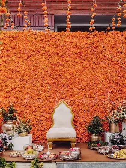 Nothing says celebration quite like a wall of fresh marigolds. This vibrant orange backdrop for a Haldi ceremony is one of my signature offerings, creating a joyful and picture-perfect spot for this happy occasion.