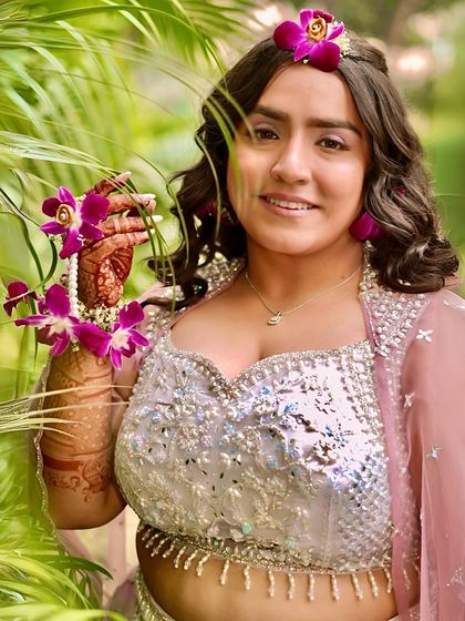 A picture-perfect glam look for a pre-wedding event. The makeup is flawless and radiant, ensuring she looks stunning in every photo.
