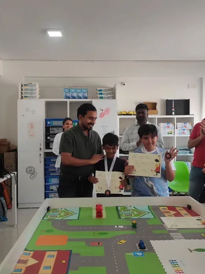 A moment of victory. These students are thrilled to receive their awards after a successful run in our autonomous school bus robotics competition.