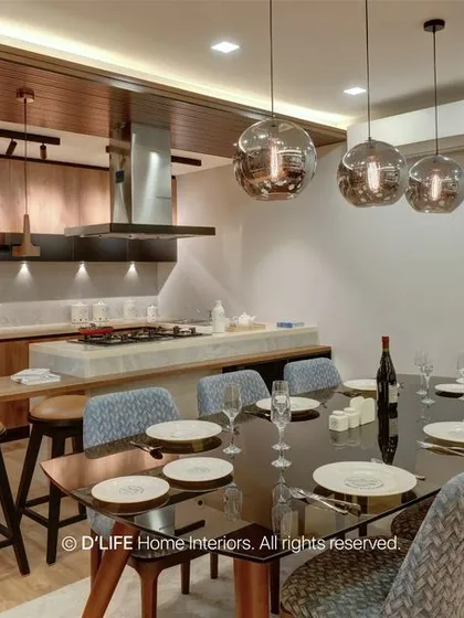 The open-plan dining and kitchen area is perfect for entertaining. The large dining table is complemented by the functional and stylish kitchen island in the background.