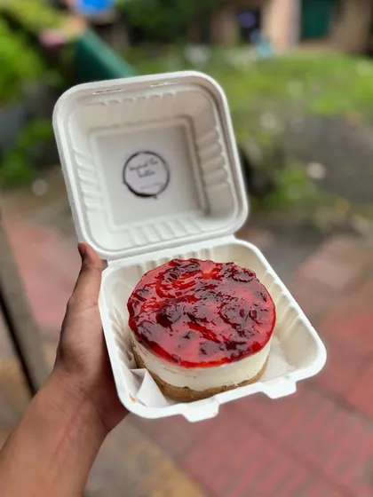 A delicious strawberry cheesecake bento. This personal-sized cheesecake has a biscuit base, creamy filling, and is topped with a bright strawberry compote.