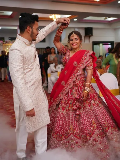 A magical first dance. The bride's classic red bridal glam, with its flawless finish, ensures she looks stunning as she twirls.